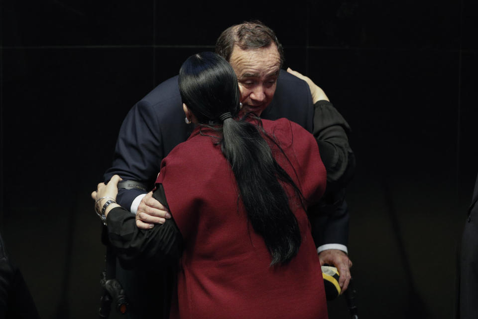 Guatemala's President Alejandro Giammattei is embraced by Mexican Senate President Monica Fernandez Balboa after he addressed lawmakers in Mexico City, Thursday, Feb. 6, 2020. (AP Photo/Rebecca Blackwell)