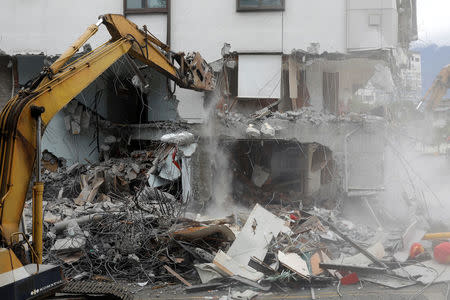 An excavator demolishes collapsed Marshal hotel after an earthquake hit Hualien, Taiwan February 9, 2018. REUTERS/Tyrone Siu