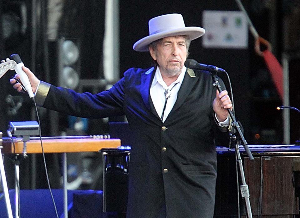 FILE - This July 22, 2012 file photo shows U.S. singer-songwriter Bob Dylan performing on at "Les Vieilles Charrues" Festival in Carhaix, western France. It's a crowded tour market and everyone is competing for your entertainment dollar. Dylan put together the Americanarama Festival of Music with My Morning Jacket and Wilco. (AP Photo/David Vincent, file)