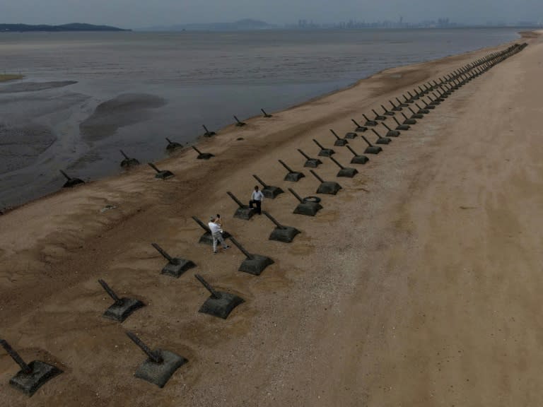 Anti-landing spikes line a beach in Taiwan's Kinmen, with mainland China visible in the background