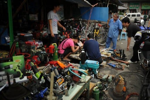 People look at industrial tools on display at a market Shanghai in August 2012. China's purchasing managers' index (PMI) stood at 50.2 last month, up from 49.8 in September, according to the China Federation of Logistics and Purchasing and the National Bureau of Statistics