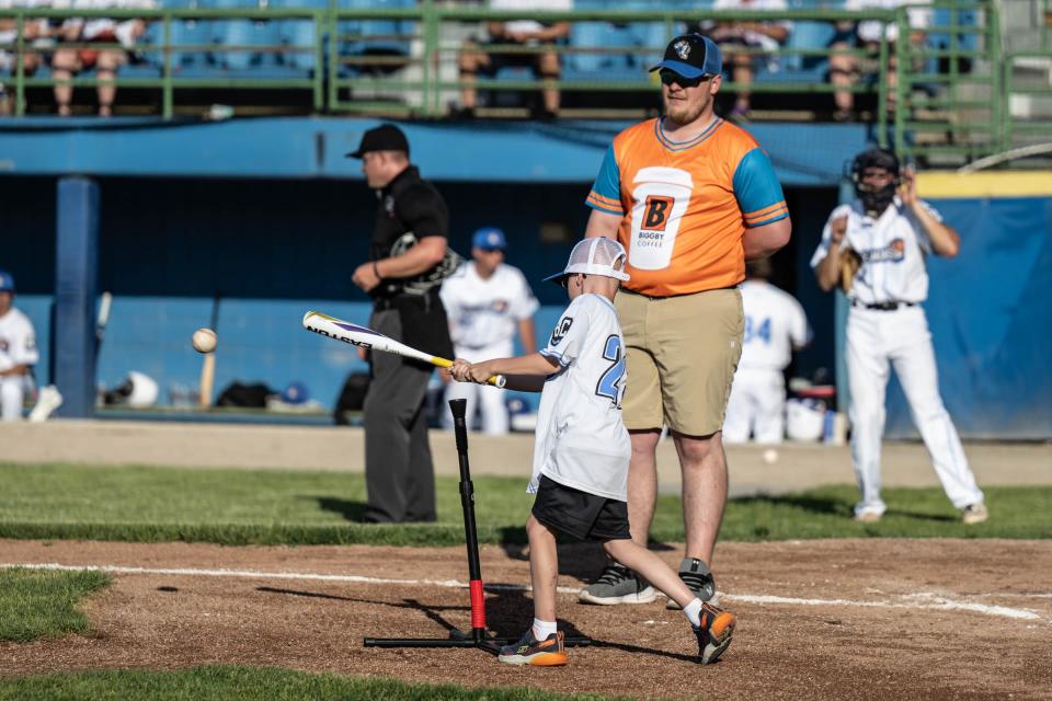 Tyler Newville, 7, get a hit as part of the entertainment during the Battle Jacks opening night at C.O. Brown Stadium on Monday, May 30, 2022