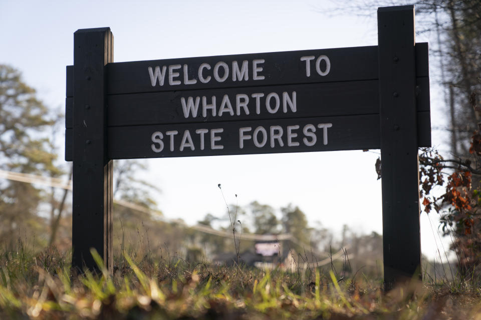 Shown is a sign to the Wharton State Forest in Washington Township, N.J., Wednesday, Dec. 20, 2023. Investigators are examining the wreckage of a TV news helicopter that crashed in the New Jersey Pinelands, killing the pilot and a photographer on board. WPVI-TV of Philadelphia says a two members of its news team were in the helicopter when it went down about 8 p.m. Tuesday in Wharton State Forest. (AP Photo/Matt Rourke)