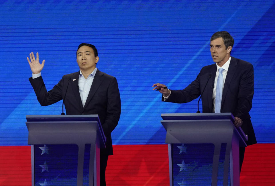 Andrew Yang, left, and former Texas Rep. Beto O'Rourke, right, respond Thursday, Sept. 12, 2019, during a Democratic presidential primary debate hosted by ABC at Texas Southern University in Houston. (AP Photo/David J. Phillip)