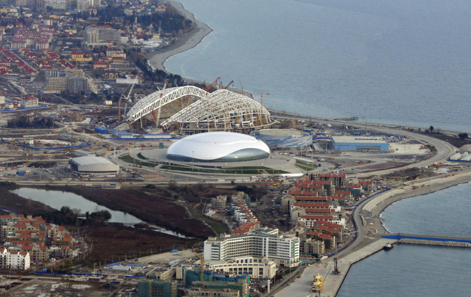 FOR STORY RUSSIA SOCHI YEAR TO GO - In this photo dated Monday, Feb. 4, 2013, an aerial view of the Olympic Park as construction works continue in the lead up to the upcoming winter games in Sochi, Russia. With just one year till the opening ceremony of the winter Olympic 2014 Sochi Games, the Black Sea resort of Sochi is a vast construction site sprawling for nearly 40 kilometers (25 miles) along the coast and 50 kilometers (30 miles) up into the mountains, with no escape from the clang and clatter of the construction works, the drilling, jack-hammering and mixing of cement. (AP Photo/Dmitry Lovetsky)