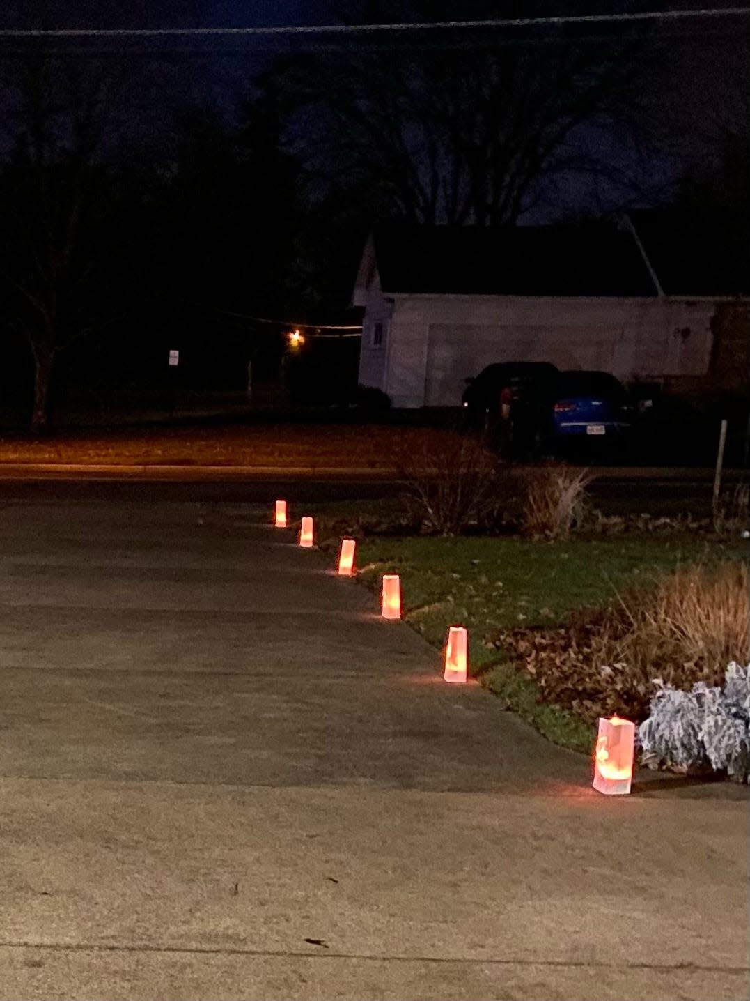 Luminaries offer a welcome to arriving family members on Christmas Eve at Mary Lee's home.