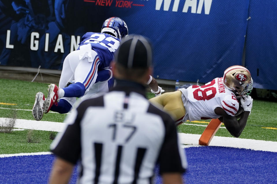 San Francisco 49ers' Jerick McKinnon, right, scores a touchdown in front of New York Giants' Logan Ryan during the first half of an NFL football game, Sunday, Sept. 27, 2020, in East Rutherford, N.J. (AP Photo/Corey Sipkin)