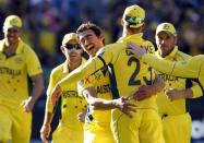 Australia's Mitchell Starc (C) celebrates with captain Michael Clarke after they dismissed New Zealand's Luke Ronchi for a duck during their Cricket World Cup final match at the Melbourne Cricket Ground (MCG) March 29, 2015. REUTERS/Brandon Malone