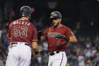 Arizona Diamondbacks David Peralta (6) celebrates his three-run home run against the Cincinnati Reds with teammate Christian Walker (53) during the third inning of a baseball game Sunday, April 11, 2021, in Phoenix. (AP Photo/Ross D. Franklin)