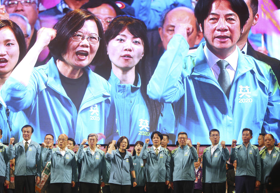 Taiwan President and Democratic Progressive Party presidential candidate Tsai Ing-wen, front fourth from left, and her running mate William Lai, fifth left, are seen on screen above as Tsai launches her re-election campaign in Taipei, Taiwan, Sunday, Nov. 17, 2019. Taiwan will hold its presidential election on Jan. 11, 2020. (AP Photo/Chiang Ying-ying)