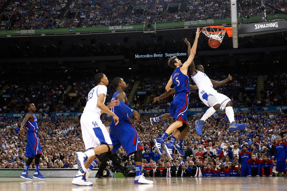 Michael Kidd-Gilchrist #14 of the Kentucky Wildcats is fouled as he goes to the basket against Elijah Johnson #15 and Jeff Withey #5 of the Kansas Jayhawks in the first half in the National Championship Game of the 2012 NCAA Division I Men's Basketball Tournament at the Mercedes-Benz Superdome on April 2, 2012 in New Orleans, Louisiana. (Photo by Jeff Gross/Getty Images)