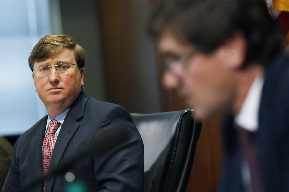 Mississippi Gov. Tate Reeves, left, listens as State Health Officer Dr. Thomas Dobbs, discusses the state's efforts to reduce and limit transmission from the COVID-19 virus, Monday, July 20, 2020, during a press briefing in Jackson, Miss. (AP Photo/Rogelio V. Solis)