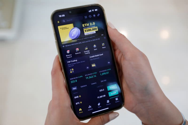 Asal Alizade, an Iranian Binance trader, displays the mobile application on her smart phone, in Dubai