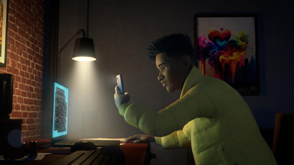Darius takes a picture of his screen with his phone in a dimly lit office in Jurassic World: Chaos Theory.