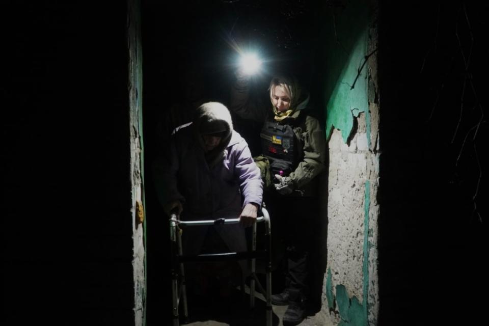 <div class="inline-image__caption"><p>It gets dark early in Ukraine now, and fighting tends to be more severe at night. Here Zaitsova is helping 80-year-old Lida out of the house.</p></div> <div class="inline-image__credit">Stefan Weichert</div>