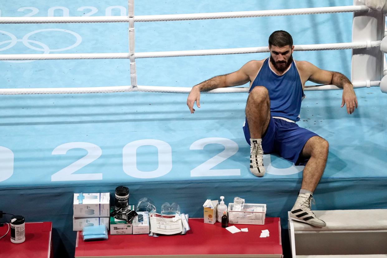 France's Mourad Aliev refuses to leave the ring after being disqualified in his men's super heavyweight quarterfinal bout against Great Britain's Frazer Clarke.