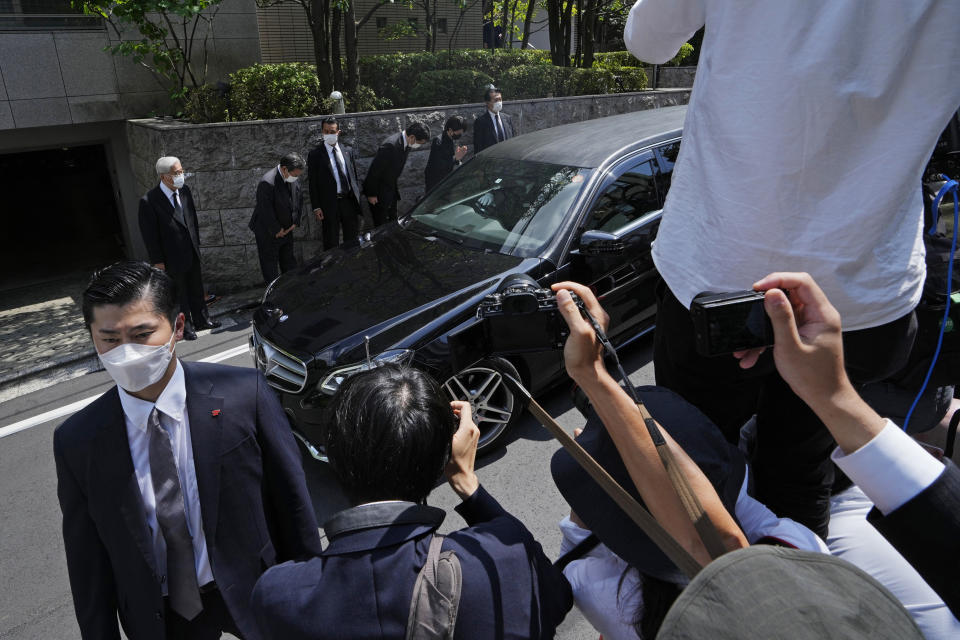 The vehicle which is believed to carry the body of former Prime Minister Shinzo Abe arrives at his home in Tokyo, Saturday, July 9, 2022. Abe was shot Friday while delivering his speech to support the Liberal Democratic Party's candidate during an election campaign in Nara, western Japan. (AP Photo/Hiro Komae)
