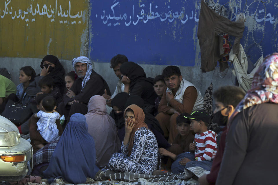 Hundreds of people gather near an evacuation control checkpoint outside the Hamid Karzai International Airport, in Kabul, Afghanistan, Wednesday, Aug. 25, 2021. The Taliban wrested back control of Afghanistan nearly 20 years after they were ousted in a U.S.-led invasion following the 9/11 attacks. Their return to power has pushed many Afghans to flee, fearing reprisals from the fighters or a return to the brutal rule they imposed when they last ran the country. (AP Photo)