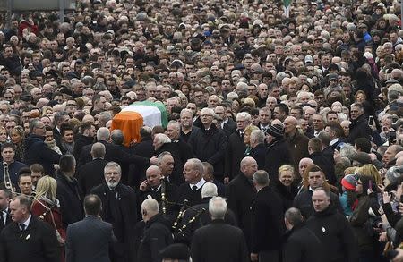 Sinn Fein President Gerry Adams (C) walks in front of the coffin of Martin McGuinness as it is carried through crowded streets during his funeral in Londonderry, Northern Ireland, March 23, 2017. REUTERS/Clodagh Kilcoyne