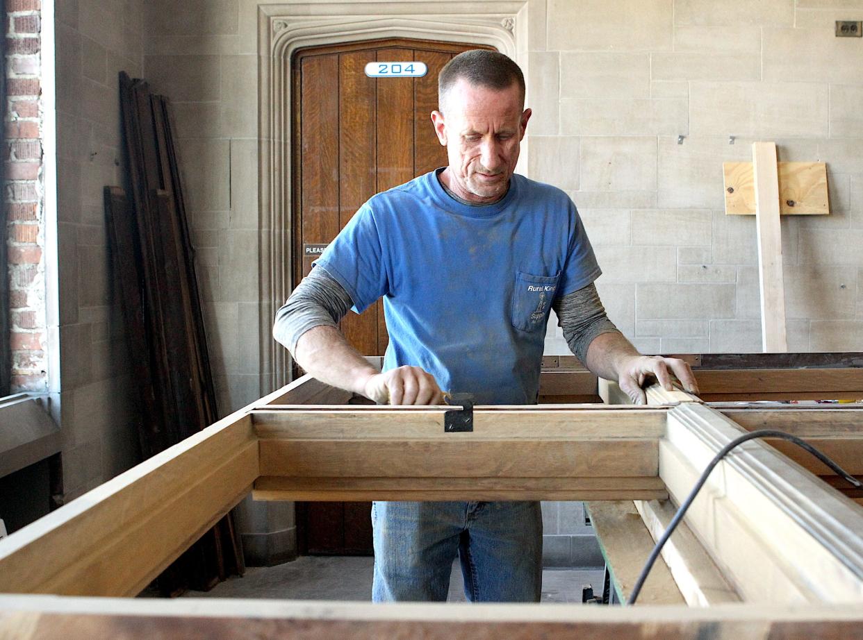 Mike Blackburn sands a walnut window frame at the old Oakland City University building, 405 I St., Monday as part of the CAP (Conrad and Parsons) Inc. renovation project. Blackburn is an employee of Central Construction in Bedford.