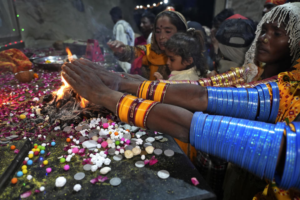 Hindu devotees perform their rituals during an annual festival in an ancient cave temple of Hinglaj Mata in Hinglaj in Lasbela district in Pakistan's southwestern Baluchistan province, Friday, April 26, 2024. More than 100,000 Hindus are expected to climb mud volcanoes and steep rocks in southwestern Pakistan as part of a three-day pilgrimage to one of the faith's holiest sites. (AP Photo/Junaid Ahmed)