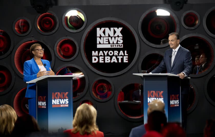 Los Angeles, CA - October 06: Los Angeles Mayoral candidate builder Rick Caruso, right, listens to Congresswoman Karen Bass speaks as they participate in the second one-on-one mayoral debate at the KNX Newsradio SoundSpace Stage in Los Angeles, Thursday, Oct. 6, 2022. (Allen J. Schaben / Los Angeles Times)