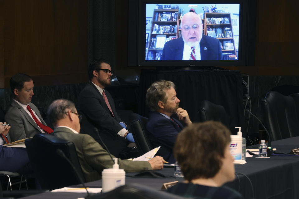 Senators and staff listen to Dr. Robert Redfield, director of the Centers for Disease Control and Prevention, speak remotely during a virtual Senate Committee for Health, Education, Labor, and Pensions hearing, Tuesday, May 12, 2020 on Capitol Hill in Washington. (Win McNamee/Pool via AP)