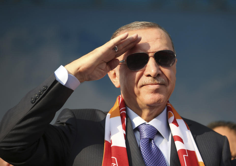 Turkish President Recep Tayyip Erdogan gives a military style salute toward his supporters during a rally in Kayseri, Turkey, Saturday, Oct. 19, 2019. Turkish Red Crescent says it has delivered humanitarian aid for 2000 people in Syrian town of Ras Al-Ayn and says it also provided aid to Tal Abyad and will continue to do so in areas cleared from Syrian Kurdish fighters.(Presidential Press Service via AP, Pool )