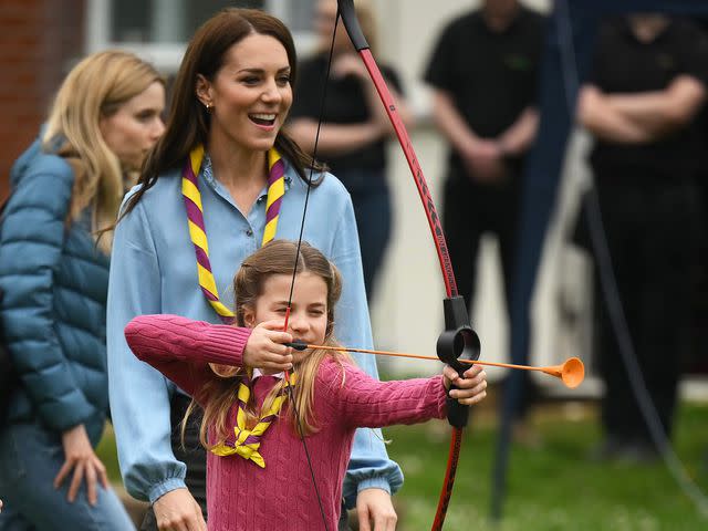 <p>Daniel Leal - WPA Pool/Getty</p> Princess Charlotte trying archery with Kate Middleton in May 2023