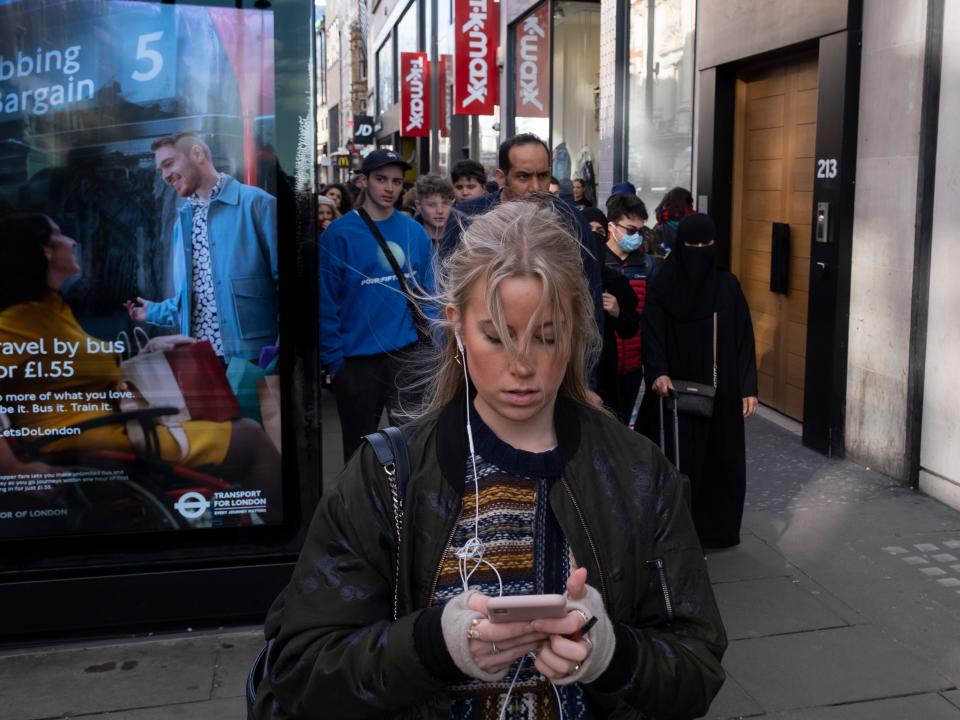 A woman checks her smartphone.