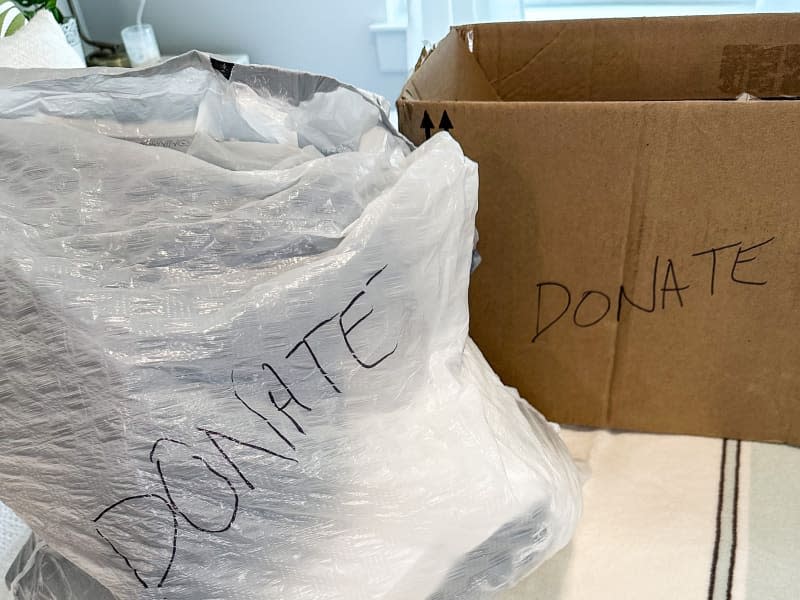 Clothes in bags and box for donation.