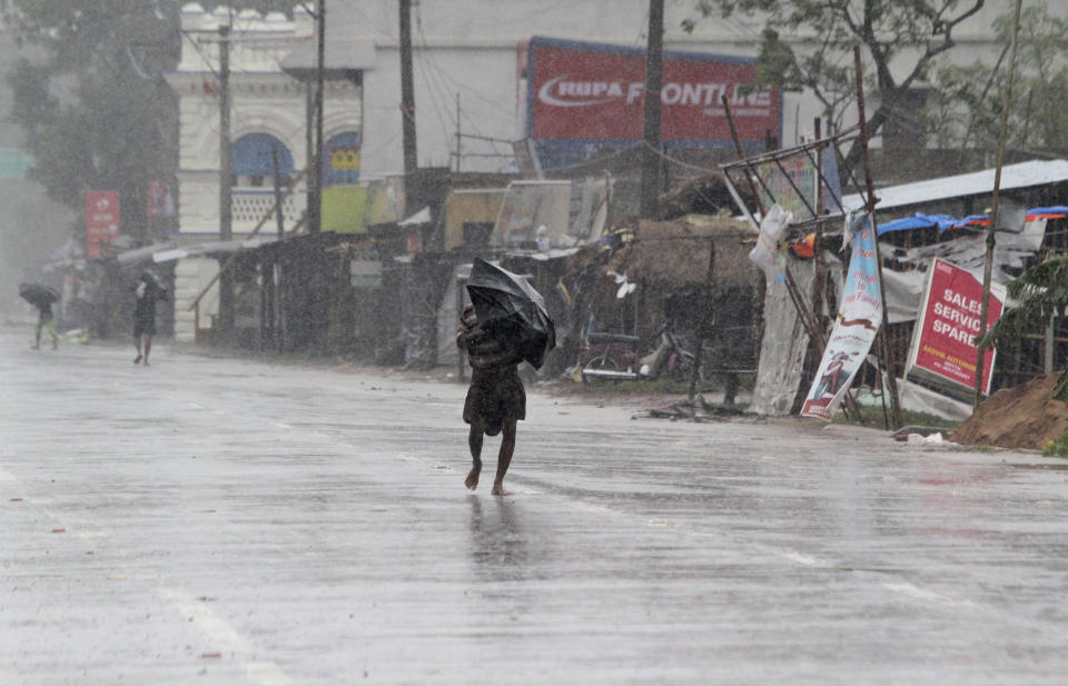 People walk with umbrellas in the rain ahead of Cyclone Amphan landfall, at Bhadrak district, in the eastern Indian state of Orissa, Wednesday, May 20, 2020. A powerful cyclone is moving toward India and Bangladesh as authorities try to evacuate millions of people while maintaining social distancing. Cyclone Amphan is expected to make landfall on Wednesday afternoon, and forecasters are warning of extensive damage from high winds, heavy rainfall, tidal waves and some flooding in crowded cities like Kolkata. (AP Photo)