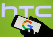 The Google logo is seen on a smartphone in front of a displayed HTC logo in this illustration taken September 21, 2017. REUTERS/Dado Ruvic/Illustration