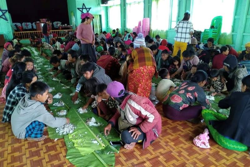 People displaced by fighting in north-western Myanmar between junta forces and anti-junta fighters eat, in Chin State