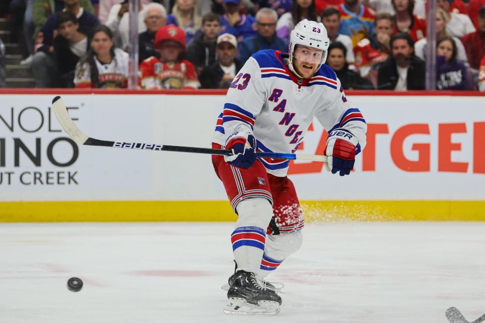 May 28, 2024; Sunrise, Florida, USA; New York Rangers defenseman Adam Fox (23) shoots the puck against the Florida Panthers during the third period in game four of the Eastern Conference Final of the 2024 Stanley Cup Playoffs at Amerant Bank Arena.