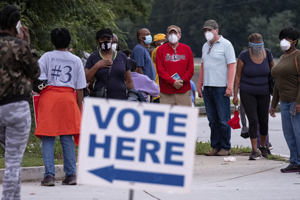 People wait in line to vote in Decatur, Ga., Monday, Oct. 12, 2020. (Ben Gray/Atlanta Journal-Constitution via AP)