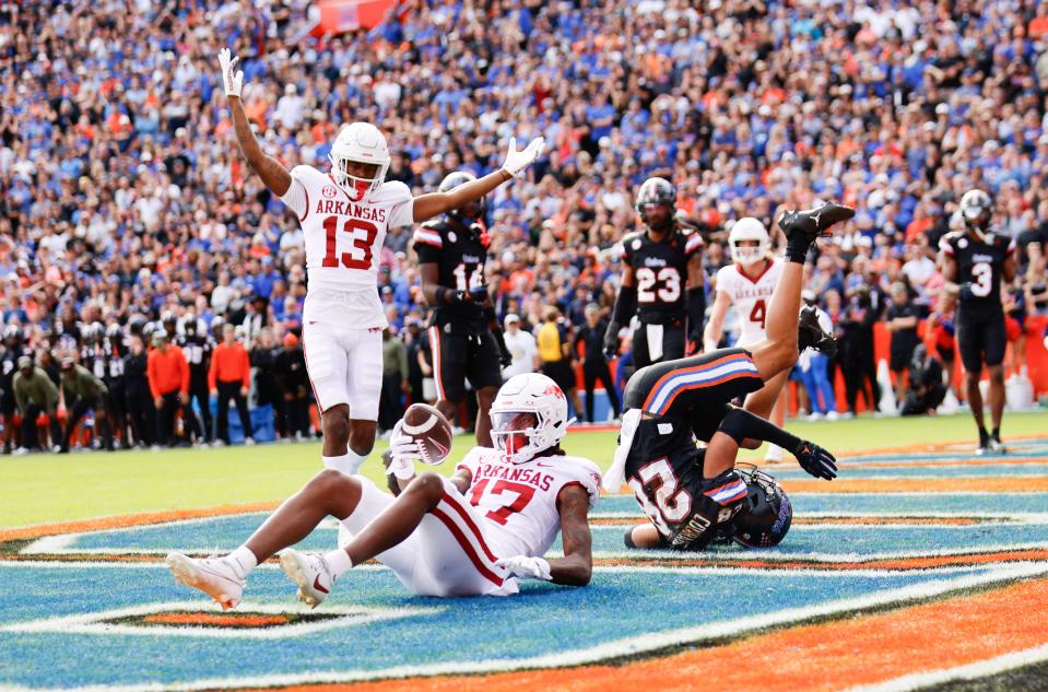 Arkansas Razorbacks wide receiver Tyrone Broden (17) catches the game-winning touchdown in overtime in front of Florida Gators cornerback Devin Moore (28) as wide receiver Jaedon Wilson (13) celebrates at Steve Spurrier Field at Ben Hill Griffin Stadium in Gainesville, FL on Saturday, November 4, 2023. [Matt Stamey/Gainesville Sun]