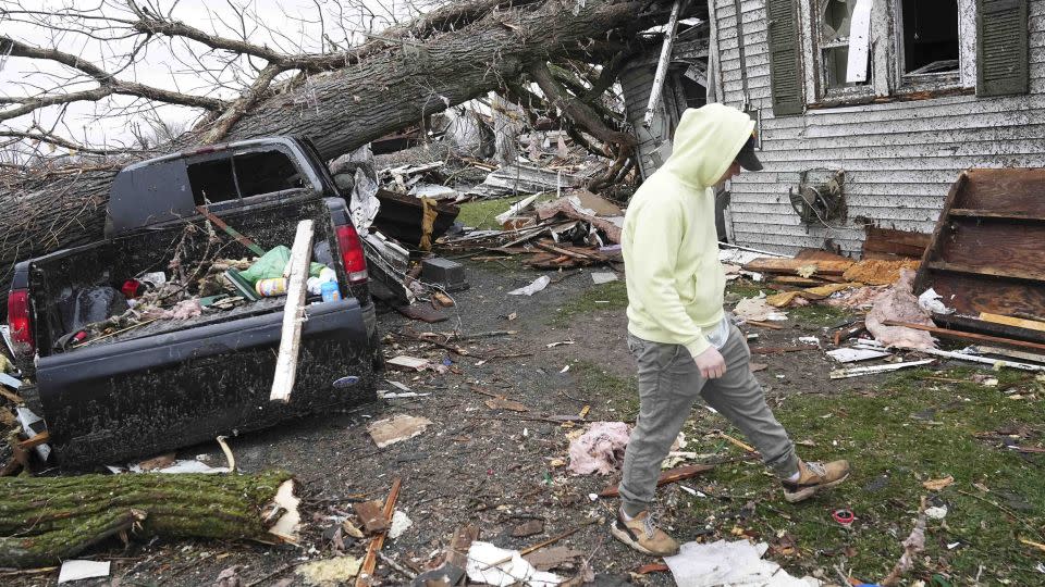 Tyler Schmitt helps clean up his brother's home after a tornado struck Lakeview, Ohio, Thursday. - Adam Cairns/Columbus Dispatch/USA Today Network