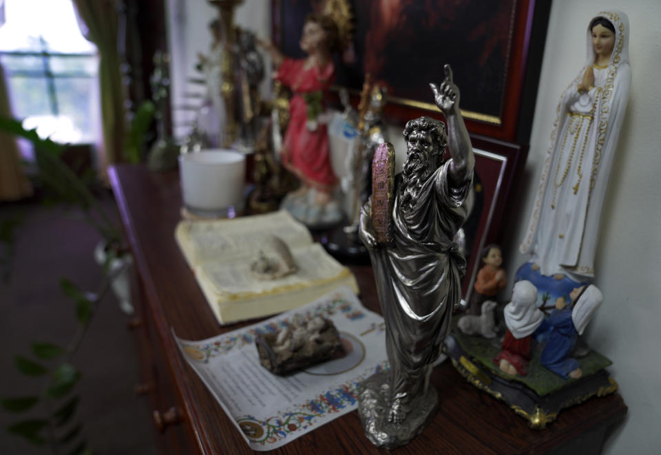 Christian icons sit on display in the office of Salvadoran lawmaker Guillermo Gallegos on Monday, May 16, 2022, in San Salvador, El Salvador. Lawmakers voted last year to uphold the country’s abortion ban, one of the world’s strictest, with some citing Scripture. (AP Photo/Jessie Wardarski)