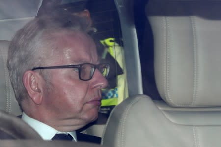 PM hopeful Michael Gove leaves the Parliament in London