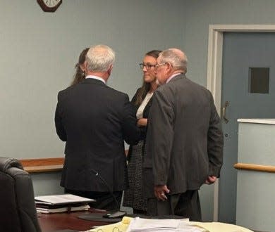 Pender County Clerk of Superior Court Elizabeth Craver talks to her legal counsel after the judge's decision to allow her to continue her role as clerk.