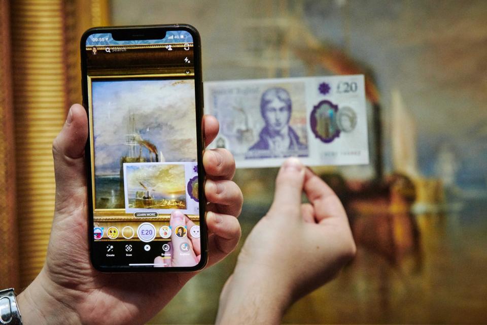 The new £20 in front of the original JMW Turner masterpiece The Fighting Temeraire at The National Gallery (PA)