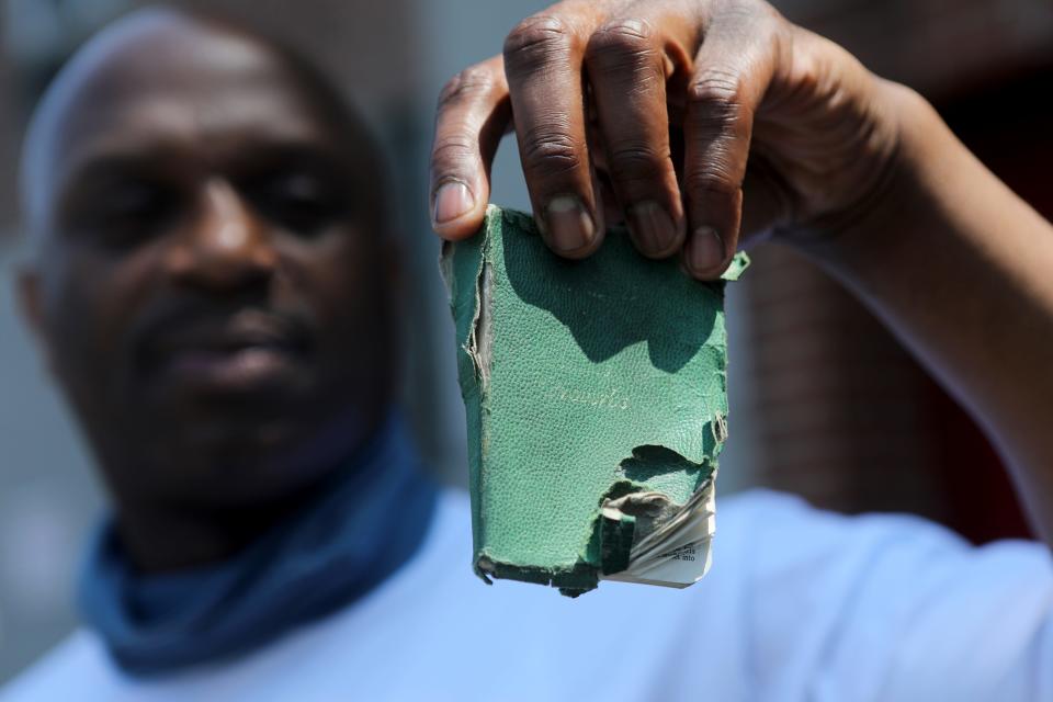 Jermaine Grant holds the Bible he had with him when he was shot by New Jersey State Police in 1998 on the shoulder of the NJ Turnpike.
