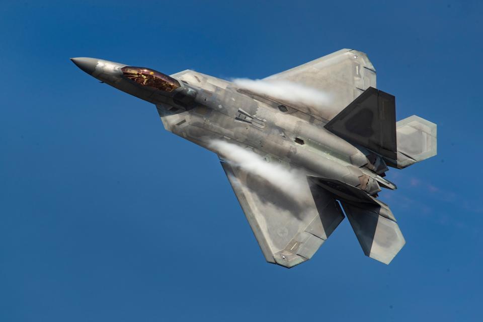 Vapor trails off the wings of an F-22 Raptor during an April 2021 demonstration flight during the Sun 'n Fun Aerospace Expo at Lakeland Linder Airport.