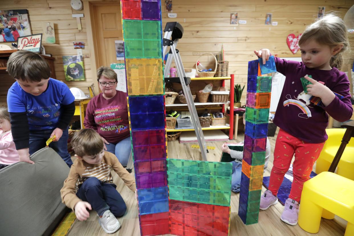 Owner Tammy Dannhoff oversees Mateo Ybarra, left, Ethan Villars and Emily Neese, right, as they play with magnetic blocks Tuesday, February 28 2023, at Kids Are Us Family Child Care in Oshkosh, Wis. 
Dan Powers/USA TODAY NETWORK-Wisconsin.