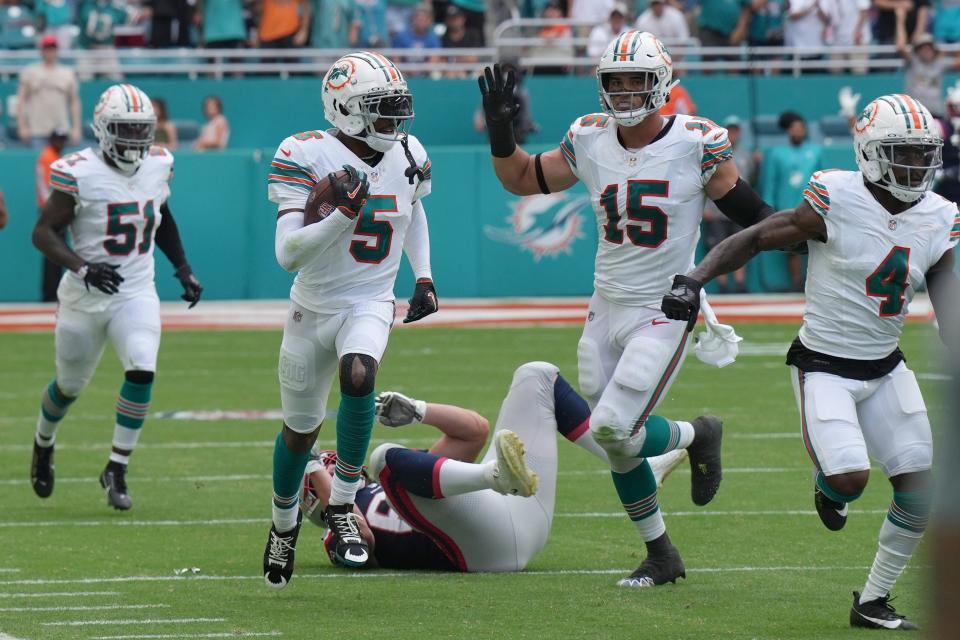 Miami Dolphins cornerback Jalen Ramsey (5) intercepts a pass against the New England Patriots during the first half of an NFL game at Hard Rock Stadium in Miami Gardens, Oct. 29, 2023.