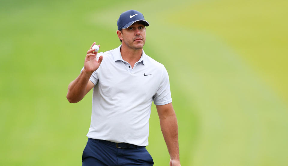 Brooks Koepka waves to the crowd