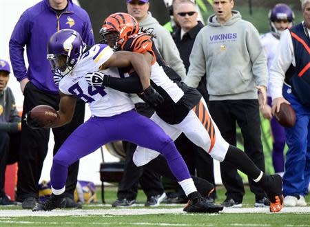 Dec 22, 2013; Cincinnati, OH, USA; Minnesota Vikings wide receiver Cordarrelle Patterson (84) is tackled by Cincinnati Bengals outside linebacker Vontaze Burfict (55) during the second half of the game at Paul Brown Stadium. Cincinnati Bengals beat Minnesota Vikings 42-14. Mandatory Credit: Marc Lebryk-USA TODAY Sports