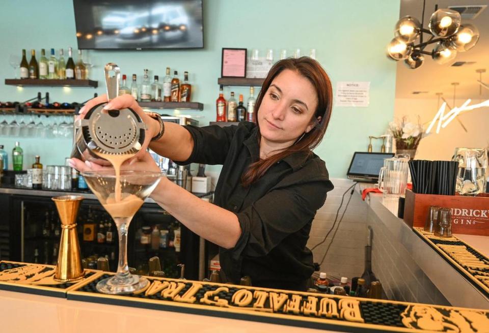 Bartender Gina Baptista pours an espresso martini while working the bar at Genesis Bistro & 8028 Salon before it closed. CRAIG KOHLRUSS/ckohlruss@fresnobee.com