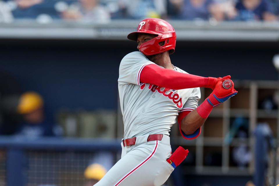 Philadelphia Phillies center fielder Johan Rojas (18) doubles against the Tampa Bay Rays in the seventh inning at Charlotte Sports Park in a Grapefruit League game.